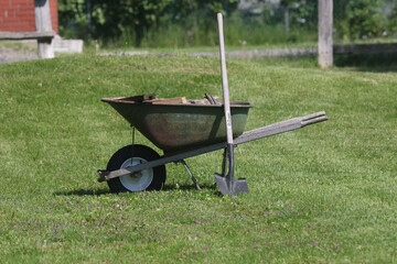 Garden planters shapped like boots and shoes and gardening equipment
