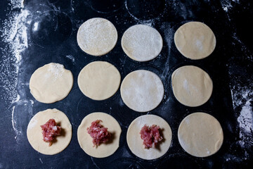 Preparation of a round shape from dough, a blank for dumplings.