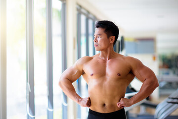 Fototapeta na wymiar Man exercising in gym. Bodybuilder lifting weights