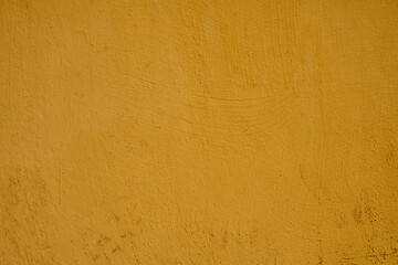 The painted wall of the old house is yellow painted as a background.