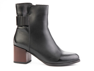 Women's autumn ankle black leather boots with red average heels, isolated white background. Right side view. Fashion shoes. Photoshoot for shoe shop