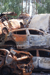 Fototapeta na wymiar war in ukraine. Car graveyard. Shot cars of civilians. russia's war against Ukraine. Burnt and blown up car. Cars damaged after shelling. irpin bucha. war crimes