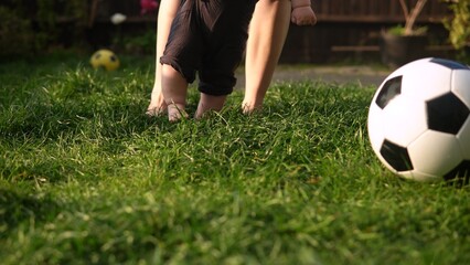 Baby Takes First Steps On Green Grass. Happy Young Cheerful Mother With Adorable Infant Baby Playing Outdoors With Love In Backyard Garden. Little Children With Parents. Family, Nature Ecology Concept