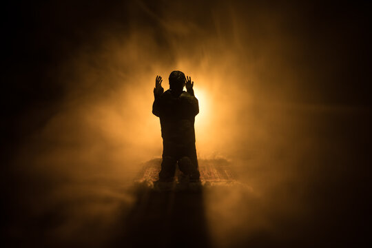 Silhouette of mosque building on toned foggy background. Ramadan Kareem background. Mosque at sunset. Praying people