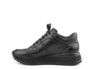 Black leather classic sneakers with laces. Casual men's style. Black rubber soles. Isolated close-up on white background. Left side view.