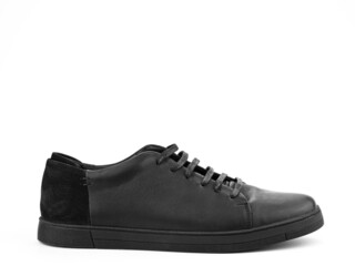 Black leather classic sneakers with laces. Casual men's style. Black rubber soles. Isolated close-up on white background. Right side view.