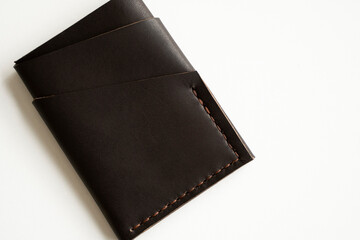Brown empty men's business handmade leather card holder with isolated on white background. Selective focus, copy space, close up.