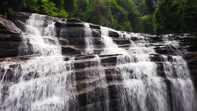Aerial drone of Waterfall in the tropical mountain jungle. Olu Ella Falls, Sri Lanka.