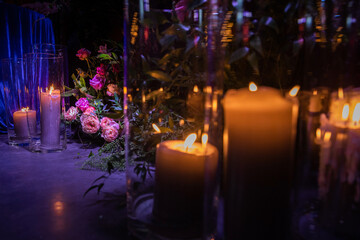 Bouquet of flowers and candles near the wedding table