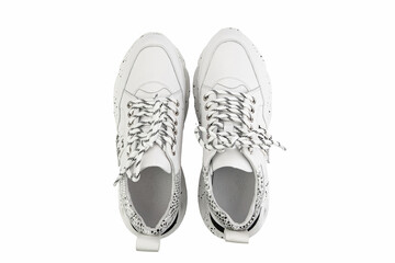 White leather sneakers. Casual women's style. White lacing and white rubber soles. Isolated close-up on white background. Top view. Fashion shoes