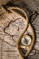 Obraz na płótnie Canvas Old golden compass on the antique and vintage mundi map. 