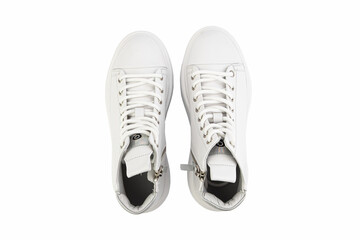 White leather sneakers. Casual women's style. White lacing and white rubber soles. Isolated close-up on white background. Top view. Fashion shoes