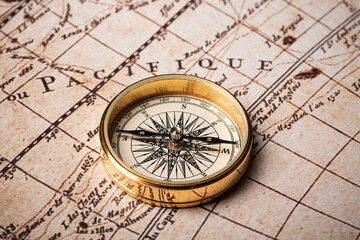 Fototapeta na wymiar Old golden compass on the antique and vintage mundi map. 