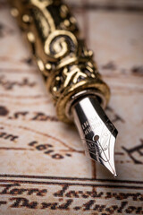 Feather pen on the vintage and antique mundi map.