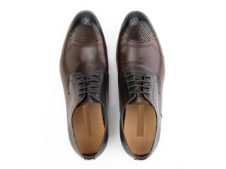 A pair of classic leather elegant men's shoes isolated white background. Groom's stylish black shoes. Isolated object close up on white background.