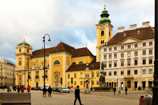 View of Vienna central square on winter day overlooking medieval parish church Schottenkirche attached to Scottish Benedictine Abbey. Historical attractions