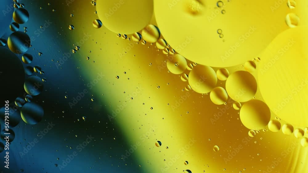 Poster real close up oil bubbles in water rotation with color gradient abstract mixing background.