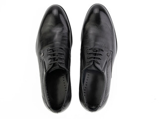 A pair of classic leather elegant men's shoes isolated white background. Groom's stylish black shoes. Isolated object close up on white background.