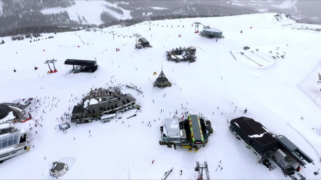 Landscape of the Kronplatz ski resort. Lifts and anonymous skiers away on a bright sunny winter day. Winter holidays recreation sport activity. Luxury life.