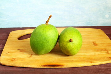 fresh green mango for pickle on wooden desk 