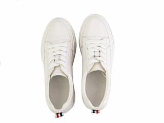 White leather sneakers. Casual women's style. White lacing and white rubber soles. Isolated close-up on white background. Top view. Fashion shoes