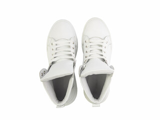 White leather sneakers. Casual women's style. White lacing and white rubber soles. Isolated close-up on white background. Top view. Fashion shoes