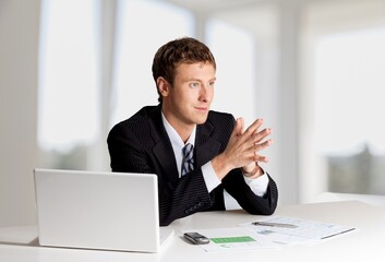 Happy mature businessman, company executive, CEO head sitting at work desk, laptop computer,