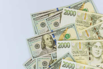 Czech korunas CZK banknotes money and American hundred dollar currency