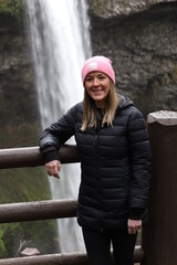 woman standing in front of waterfall
