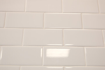 White tiles in the shape of bricks on the wall