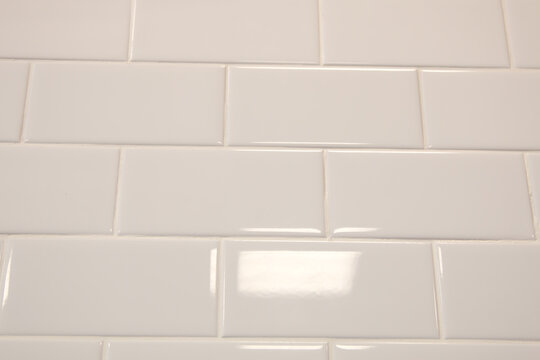 White tiles in the shape of bricks on the wall © Рустем Рафилович