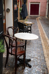 Closed cafe, rainy day in South of France, narrow streets and colorful buildings in Cassis, Provence, France
