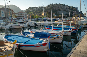 Fototapeta na wymiar Sunny day in South of France, view on old fisherman's port with boats and colorful buildings in Cassis, Provence, France