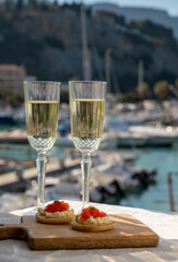 Pairing of blinis with sour cream and salted salmon red caviar and French champagne brut sparkling...