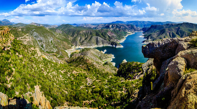 horizontal panoramic of lake in middle of the valley surrounded  of mountains with green hills in sky with clouds in zimapan hidalgo 