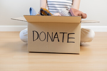 Recycling, Donation for poor, asian young woman, girl sitting pack on floor at home, put on stuff...