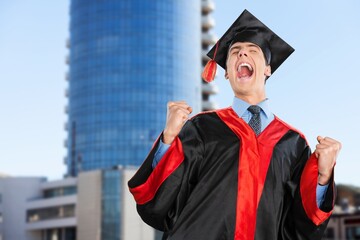 Man graduation in hat and stand on cityscape, education concept