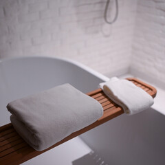 Fototapeta premium white towels put on bathtub in the bathroom
