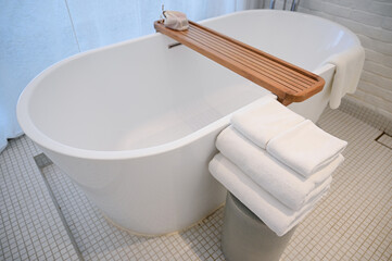 white bathroom with towels and bathtub