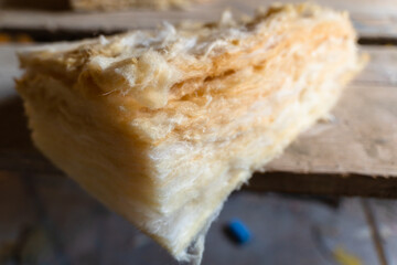 Scraps of yellow glass wool close-up. Multilayer insulation