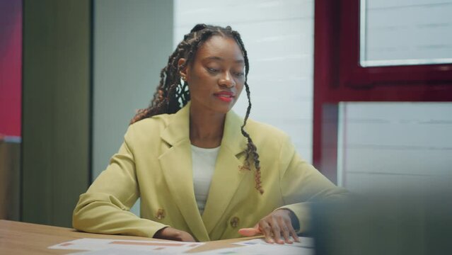Making a first impression. Young black man meets potential employer in office for interview. Welcome to the company. Smiling black woman sitting at office desk and talking to during job interview