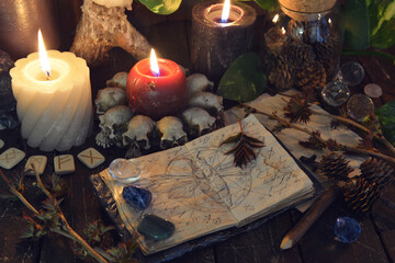 Wicca, esoteric and occult still life with vintage magic objects and candles on witch table altar...