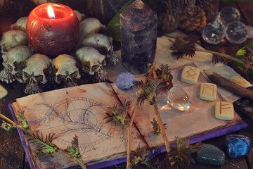 Wicca, esoteric and occult still life with vintage magic objects and open book on witch table altar...
