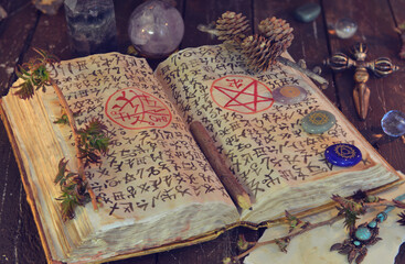 Wicca, esoteric and occult still life with vintage magic objects and grimoire on witch table altar...