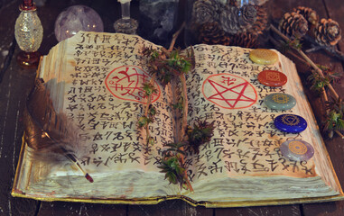 Wicca, esoteric and occult still life with vintage magic objects and grimoire on witch table altar...