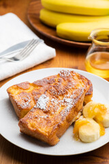 Fototapeta na wymiar 朝食のテーブルの上にバナナとオレンジマーマレードを添えたカリカリ食感のキャラメルフレンチトースト