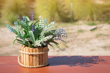 Beautiful flowers basket on wood table