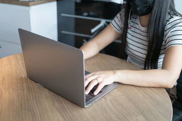 Naklejka premium Working from home on laptop while typing chat to customer communicates on internet in home office