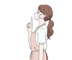 マスクをつけて指を差す横を向いたエプロン姿の女性