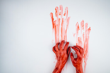 Female hands in blood on a white background. 